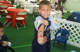 Boy with painted tattoo on his arm